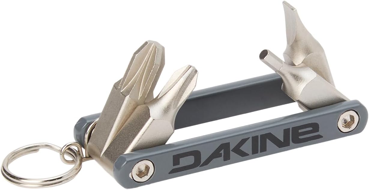 Dakine Ski Multi Tool being used to tighten a ski binding on a snowy slope